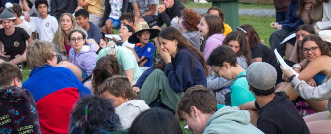 A group of neurodivergent kids at a summer camp for children on the autism spectrum are gathered around for activities!