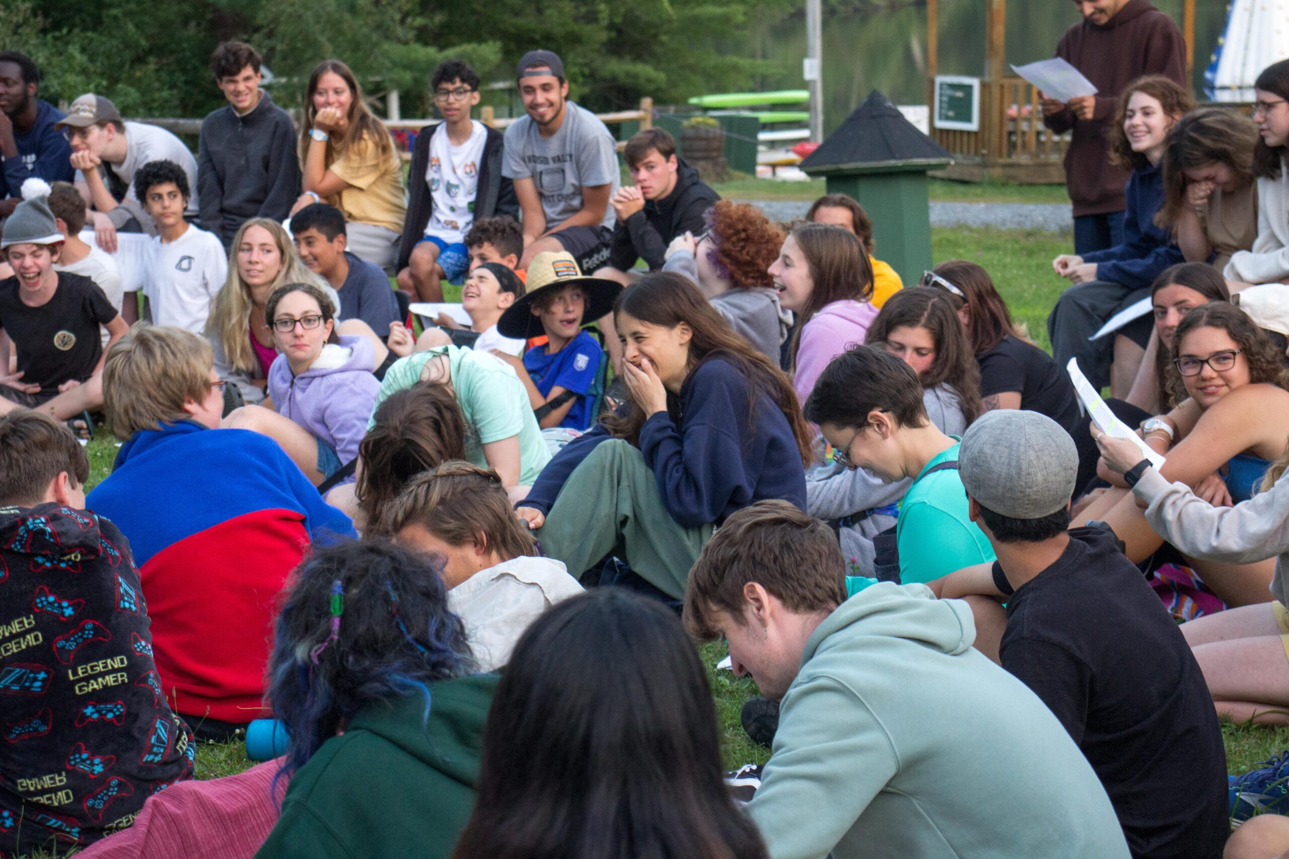 A group of neurodivergent kids at a summer camp for children on the autism spectrum are gathered around for activities!